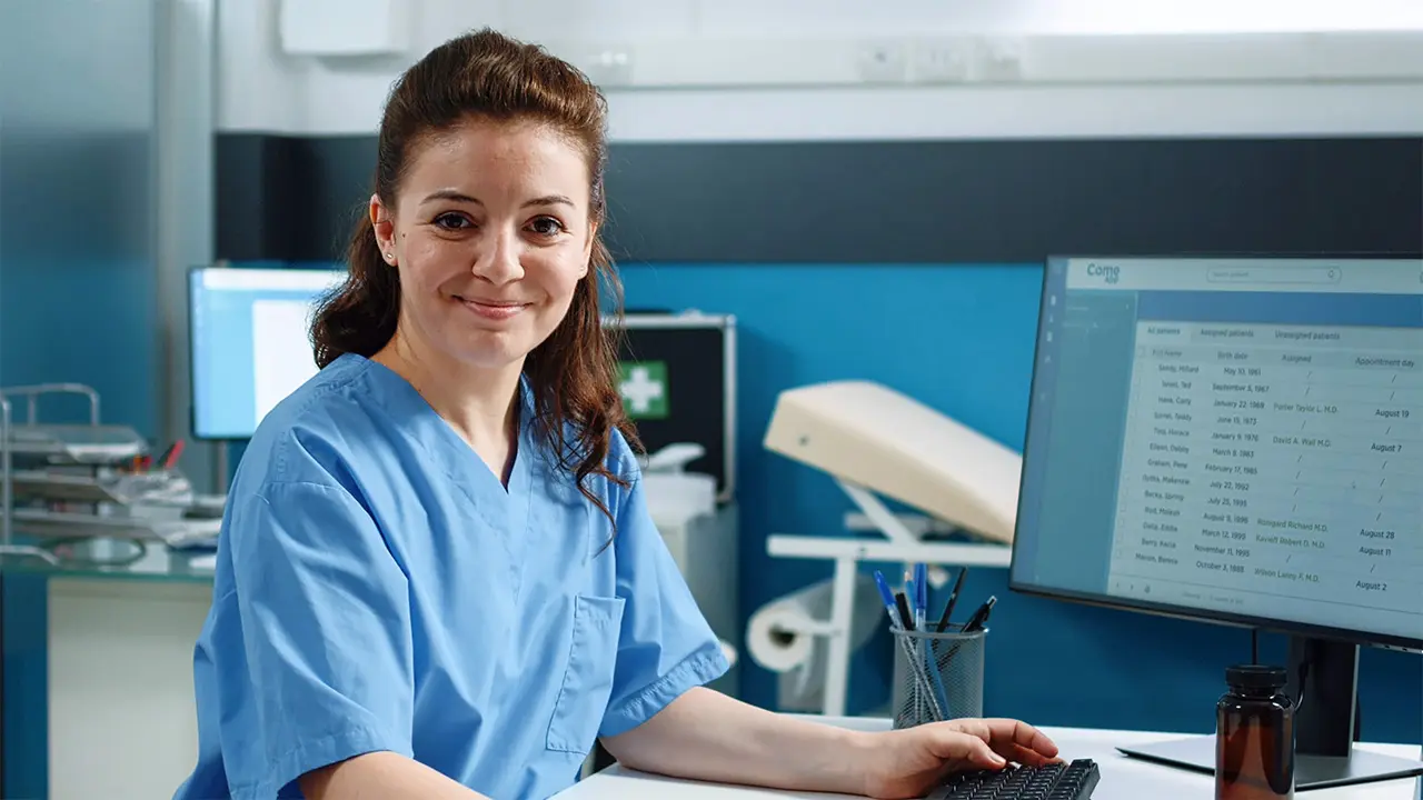 MRP Nurse at Desk Smiling-